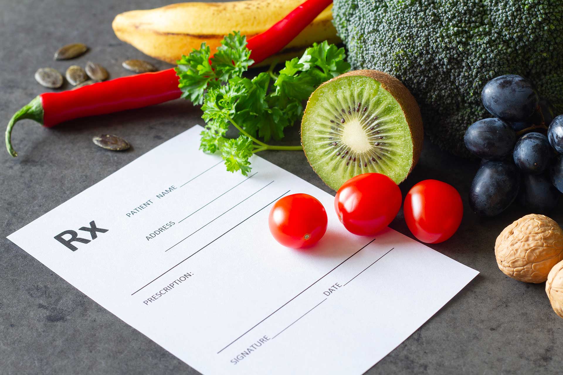 Blank prescription form surrounded by colorful fruits, vegetables, herbs, and seeds.