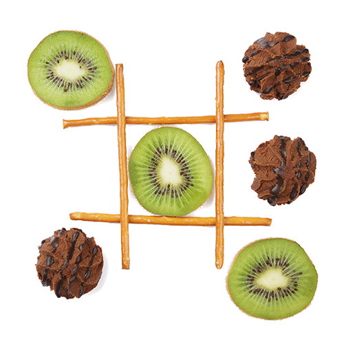 Tic-tac-toe board made with pretzel sticks, with kiwi slices and chocolate cookies as game pieces.