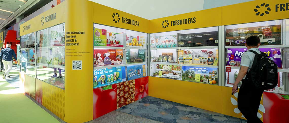 Yellow trade show kiosks labeled "FRESH IDEAS" with product displays.