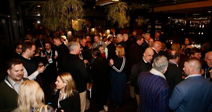 business professionals standing and talking in small groups at a IFPA Member Networking Event at Hort Connections