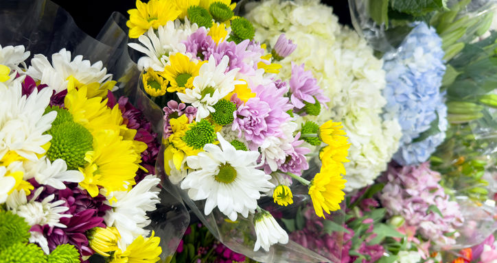 grocery store display of various flower bouquets