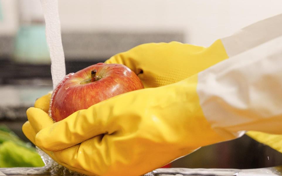  Washingfruits and vegetables with latex gloves in the sink