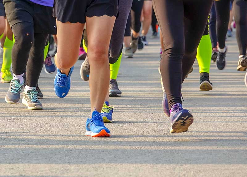 Feet of people running on marathon race