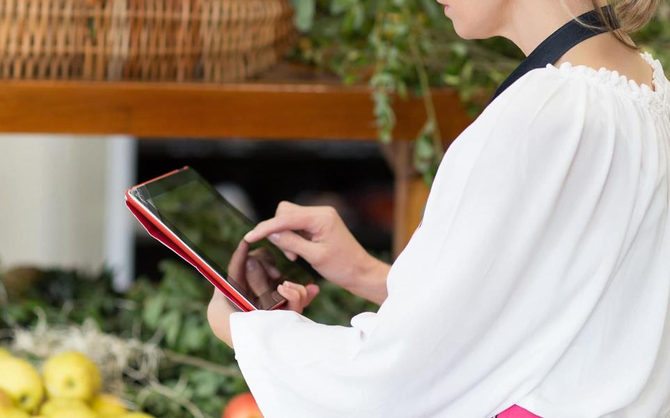 Woman Holding Digital Tablet In Grocery Store