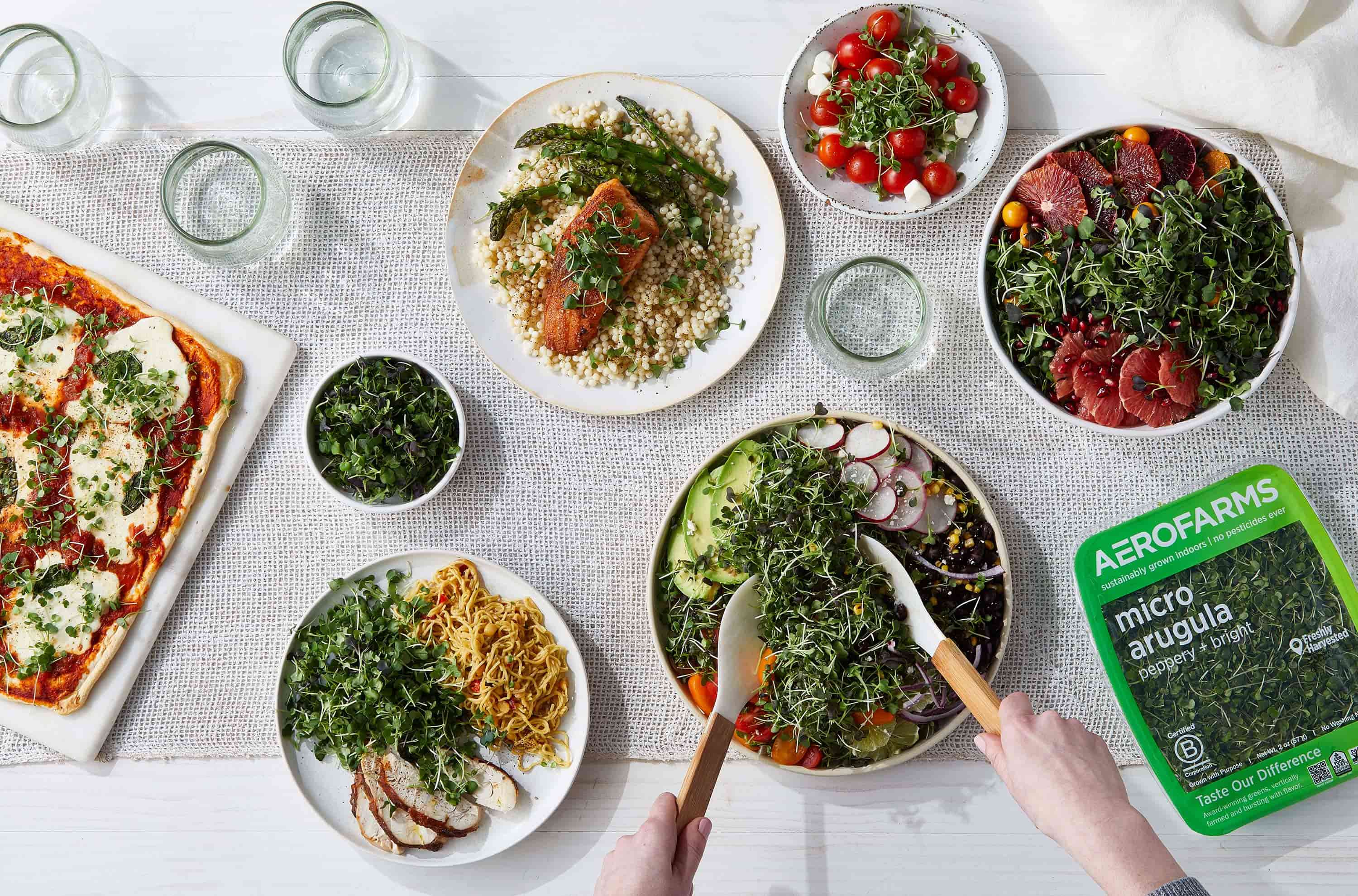 Table setting from above showing bowls full of Aerofarms micro arugula.