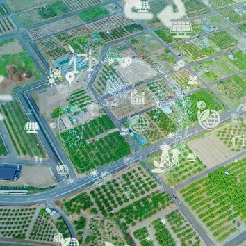 Aerial view of agricultural fields with superimposed icons of sustainability and technology.