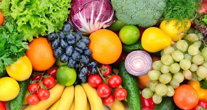 Colorful fresh fruits and vegetables laid out in a pile