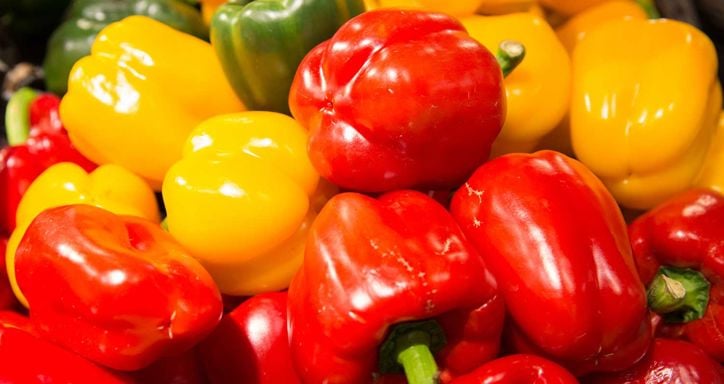 A pile of red, yellow, and green bell peppers.