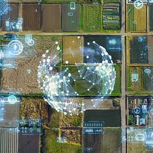 Aerial view of farmland with a digital network overlay.